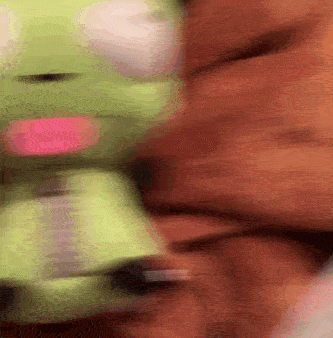 Sped up gif of a hand feeding a burger to a plushie of Invader Zim character Gir.